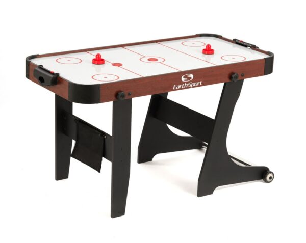 EarthSport air hockey table set up for play, with two red strikers, a puck, and the manual score counter.